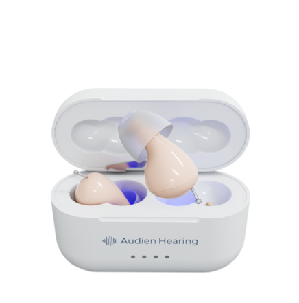 Audien Hearing Atom 2 hearing aids with open charging case showing one device elevated

